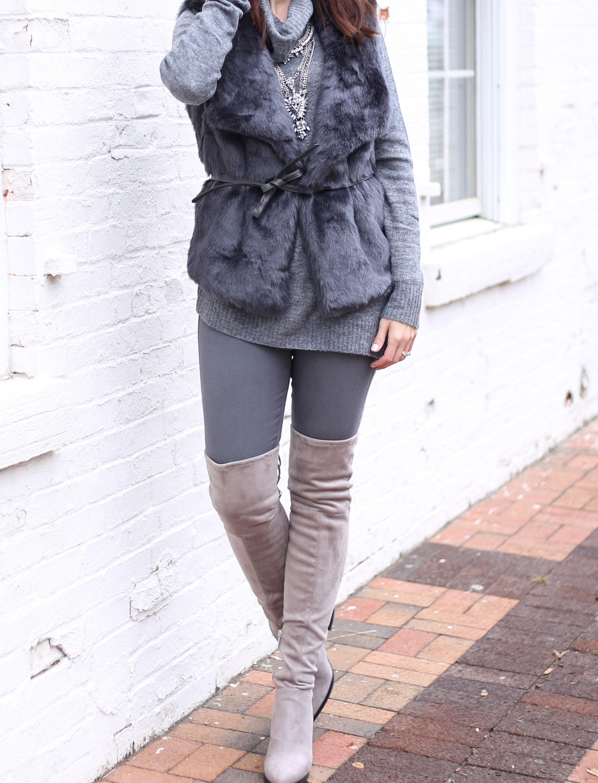 blogger Anna Monteiro of Blushing ROse Style wearing LOFT faur fur vest and Mrac Fisher over the knee alinda boots in grey