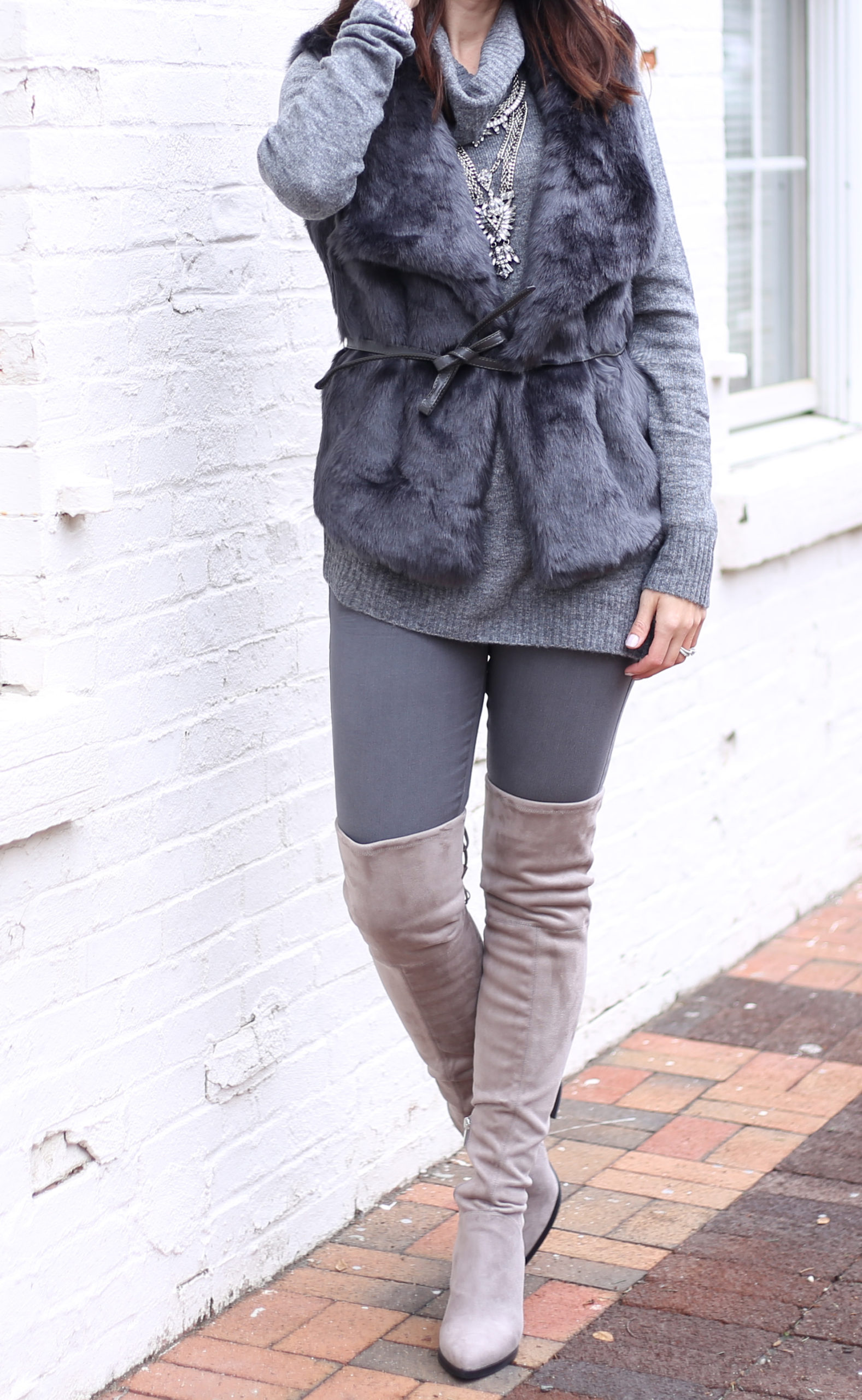 blogger Anna Monteiro of Blushing ROse Style wearing LOFT faur fur vest and Mrac Fisher over the knee alinda boots in grey