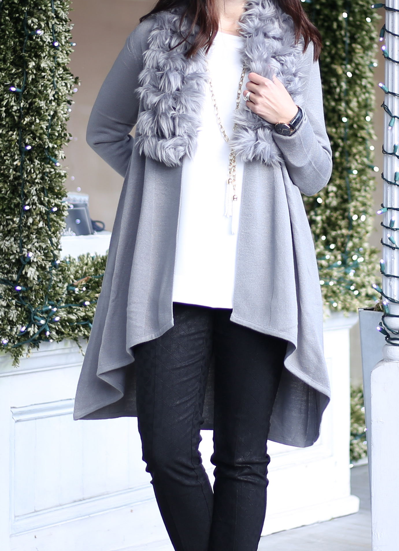 fashion blogger Anna Monteiro of blushing rose style wearing faux fur trimmed cardigan from Macys, olive and piper necklace and a white structured blouse