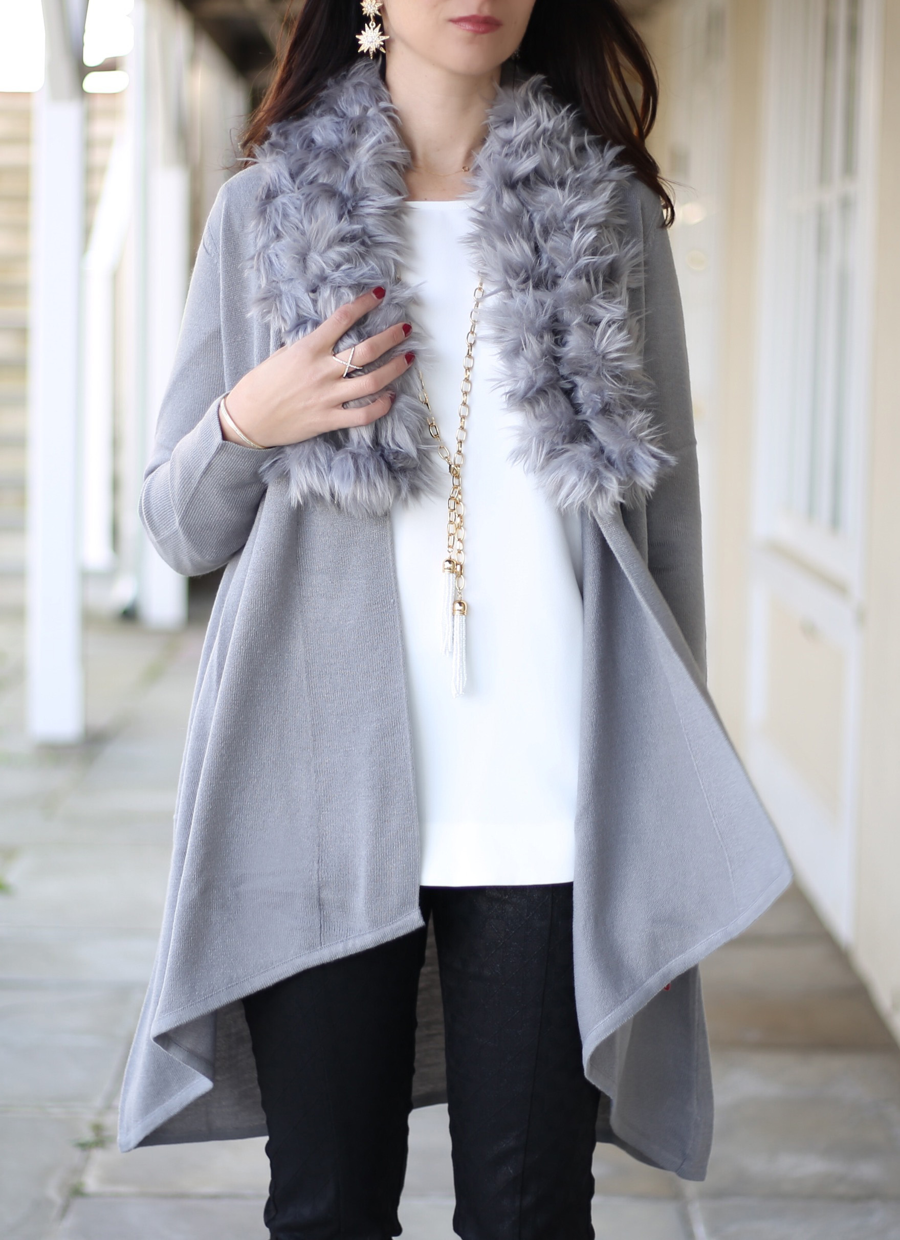 blogger Anna Monteiro of Blushing Rose Style wearing outfit for the office holiday party: Alfani faux fur trimmed cardigan in grey, Alfani white structured blouse from Macys, and Olive and Piper jewelry