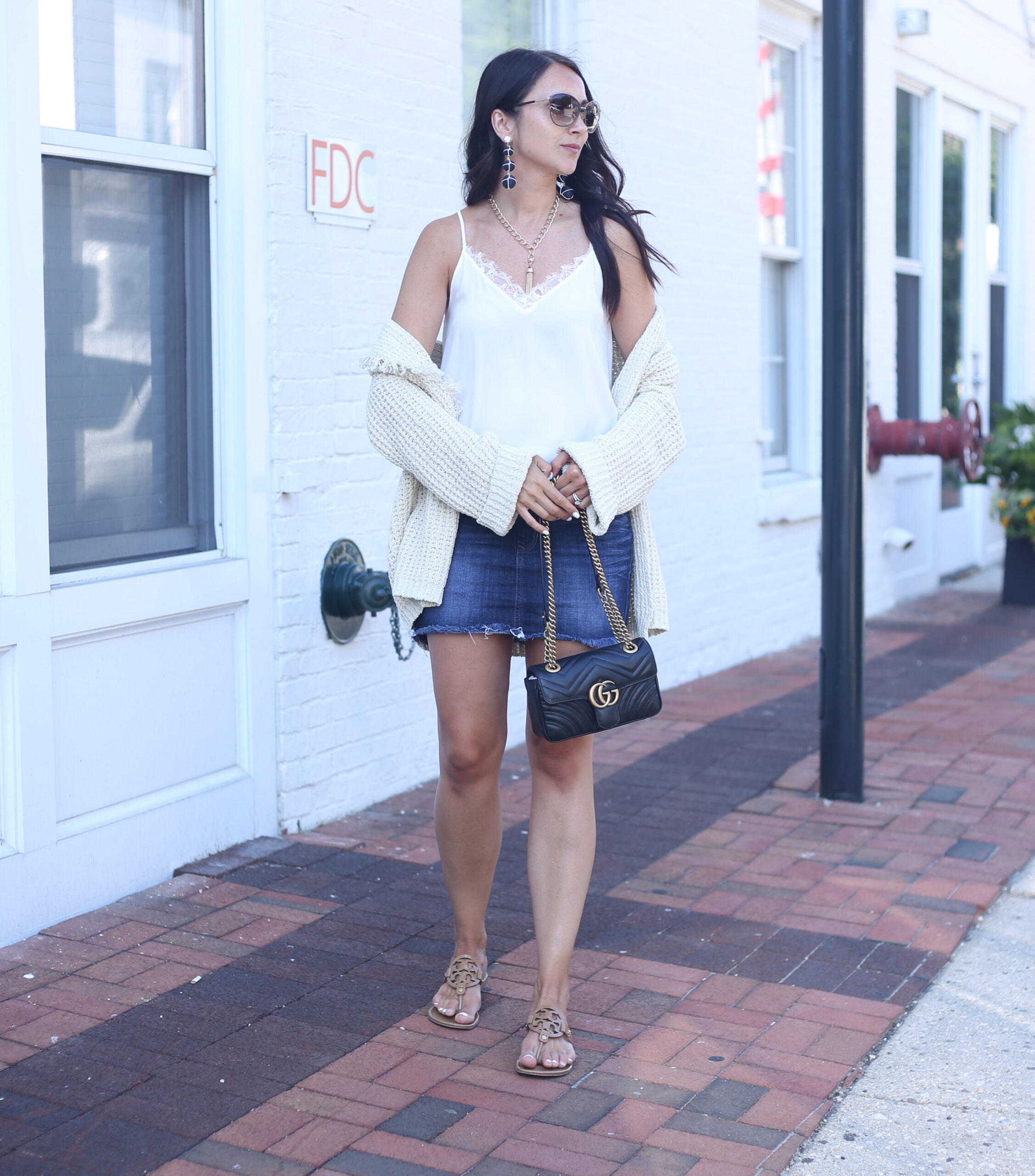 blogger Anna Monteiro of blushing rose style blog wearing gucci bag and denim skirt from express and tory burch miller sandals