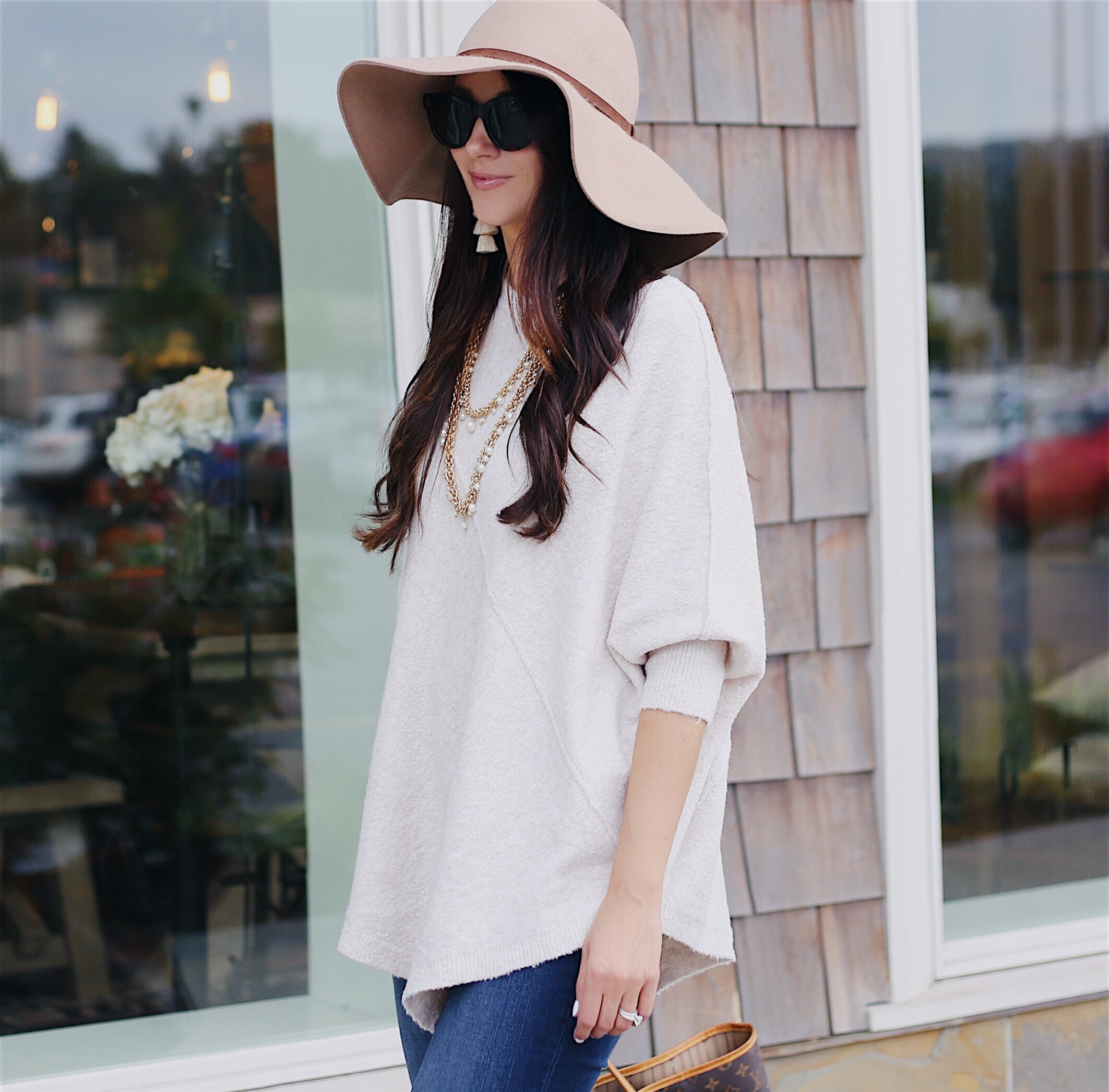 Blogger Anna Monteiro of Blushing Rose Style wearing cute fall outfit, poncho, floppy hat and over the knee boots