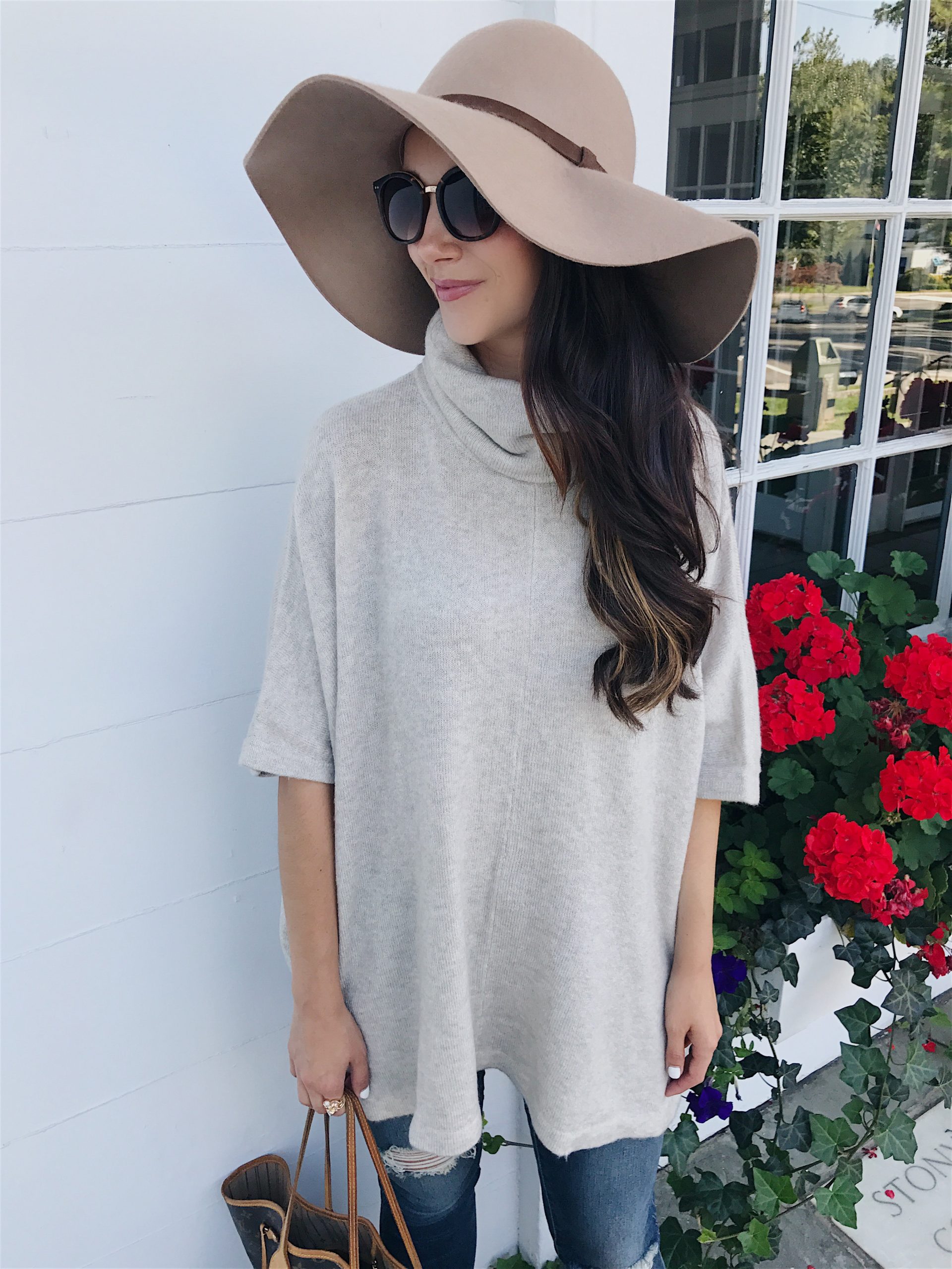 blogger Anna Monteiro of Blushing Rose Style wearing cute fall outfit sweater poncho, floppy hat and ankle brown booties