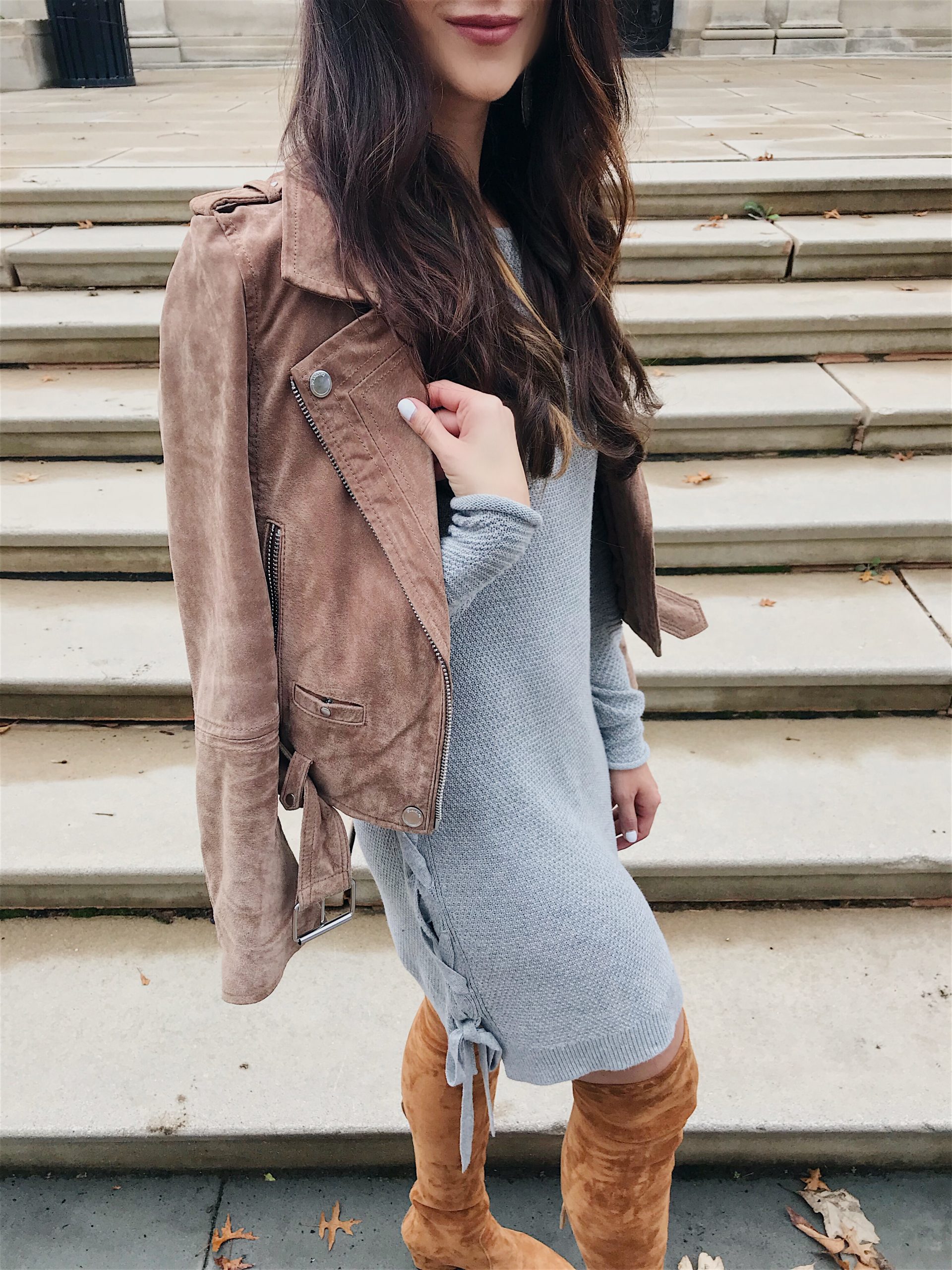 blogger Anna Monteiro of blushing rose style wearing suede moto jacket with grey sweater dress and cognac over the knee boots in tunic top styled 3 ways