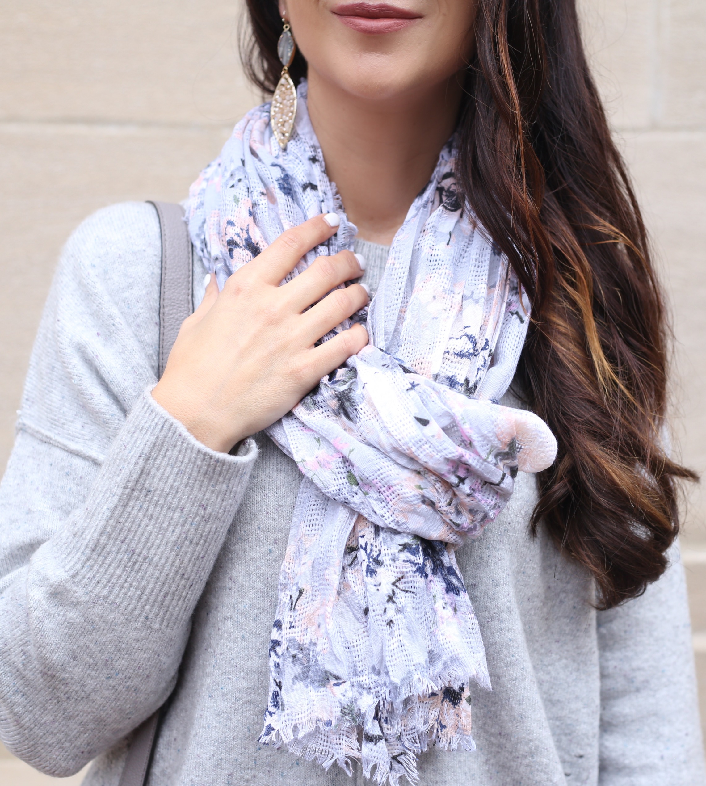 blogger Anna Monteiro wearing floral print scarf with grey oversized sweater in cozy fall sweaters