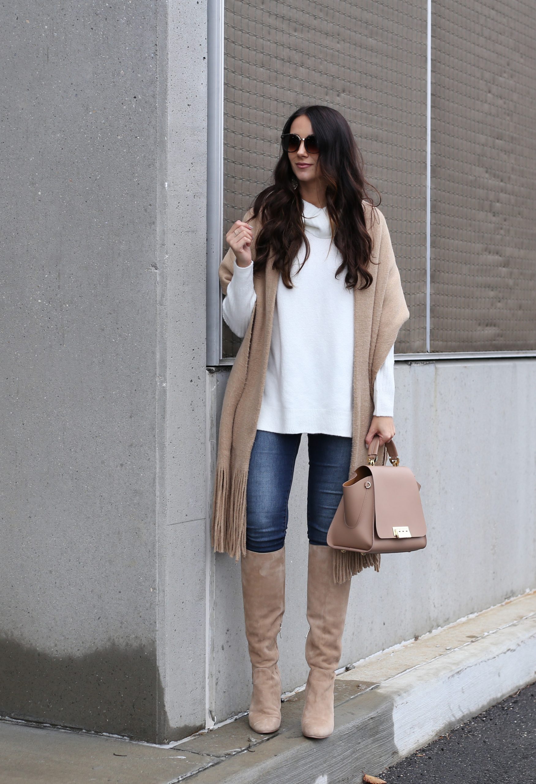 blogger Anna Monteiro of Blushing ROse style wearing chunky scarf tunic sweater and tall boots in casual holiday outfit