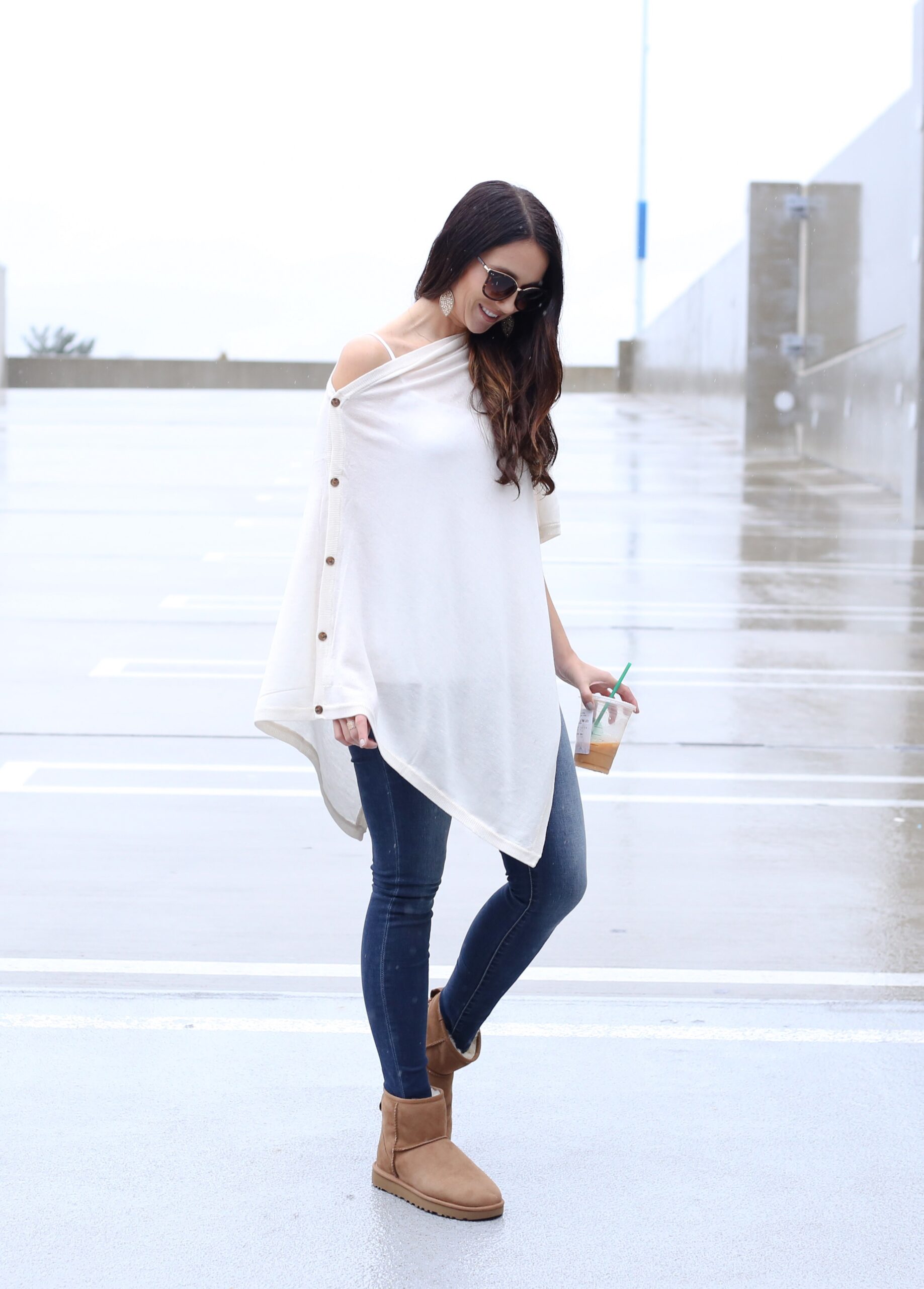 Anna Monteiro of blushing rose style blog wearing cute fall outfit poncho ugg boots in ugg season