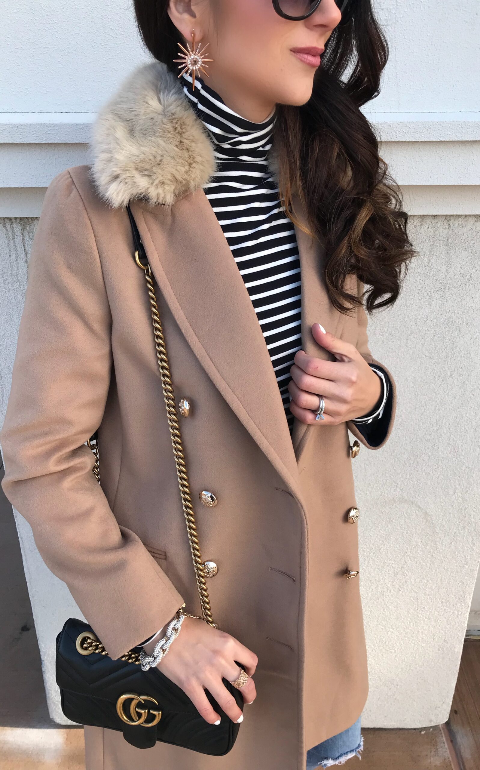 anna monteiro of blushing rose style blog wearing faux fur camel coat, striped turtleneck and cozy fall outfit