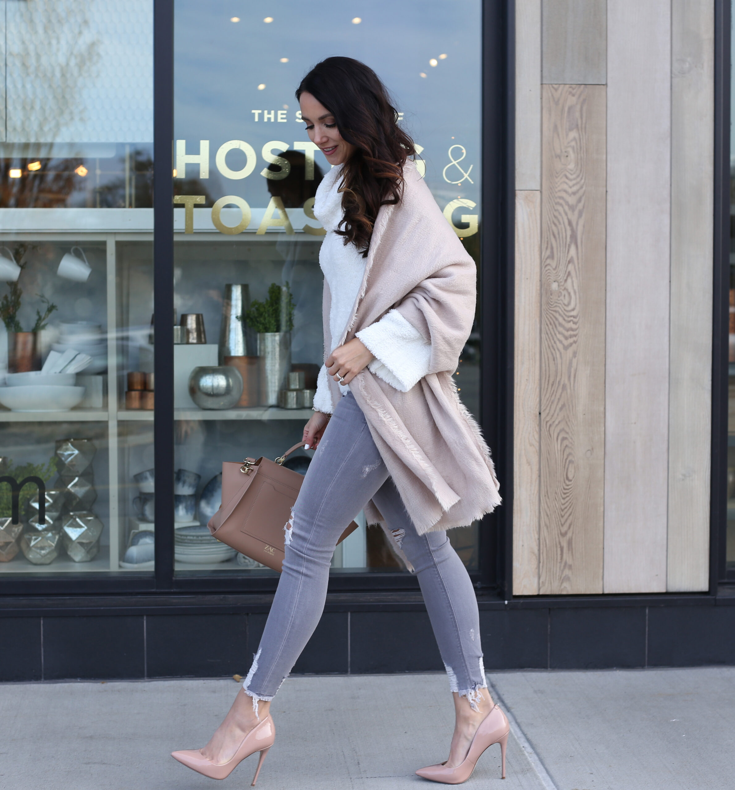 cozy holiday outfit with blush nude pumps skinny jeans and white cozy sweaters