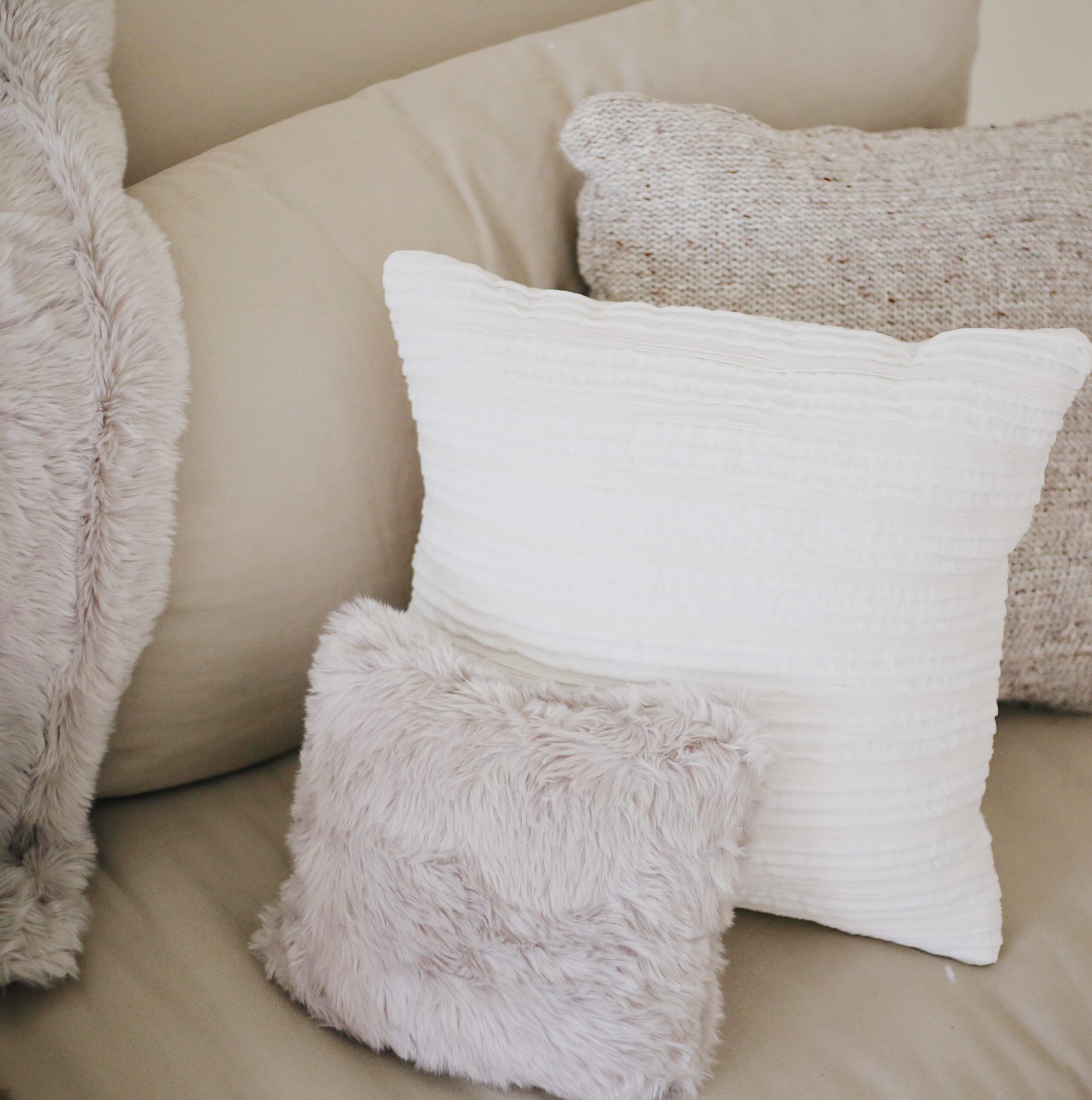 fur pillows. cozy pillows, white couch, holidays at home, holiday home decor