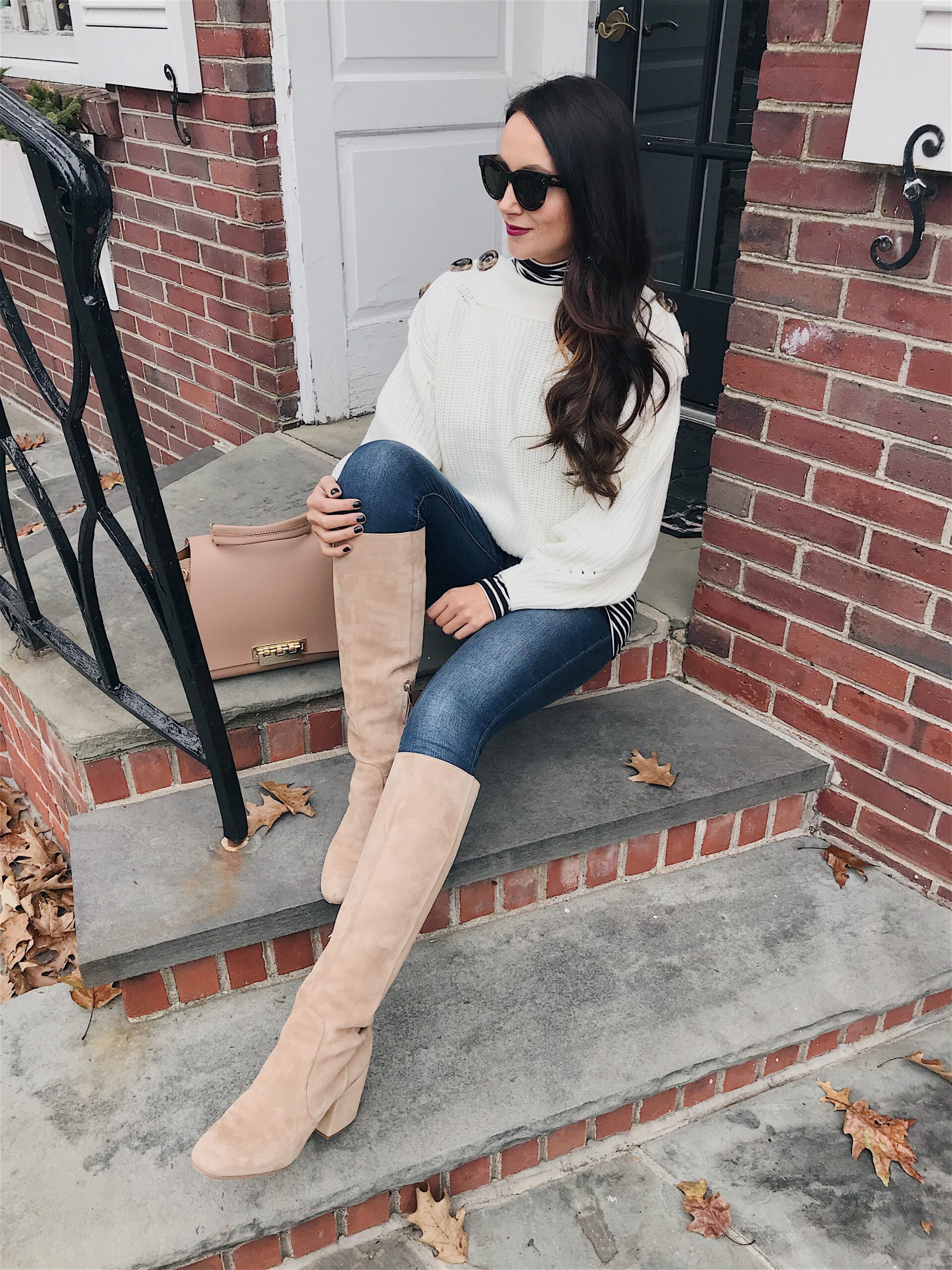 blogger anna monteiro of blushing rose style blog wearing cute winter outfit, striped turtleneck, knee high boots and beanie in 3 must have boot styles to own this season