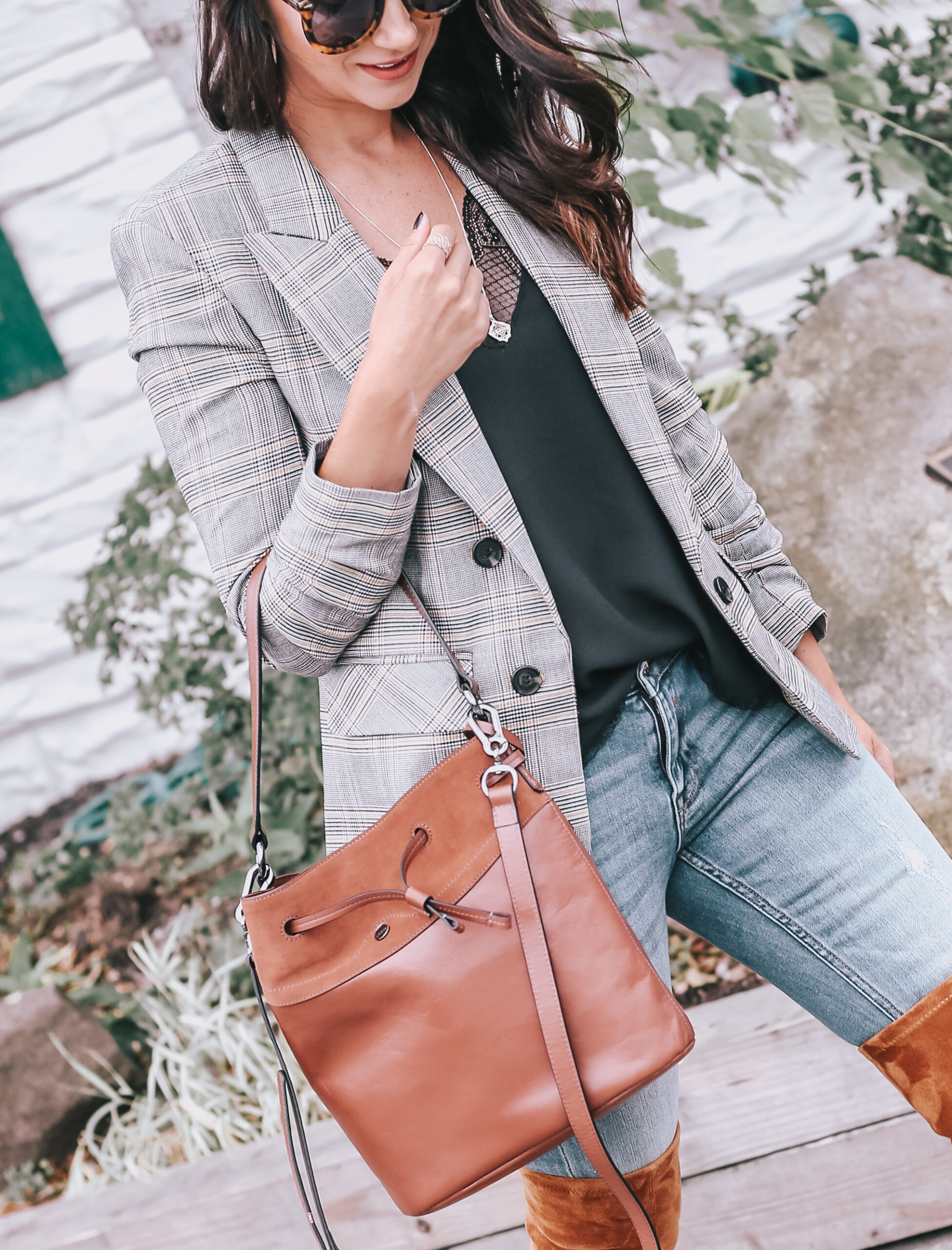 fall outfit with bukcet bag, over the knee boots and skinny jeans