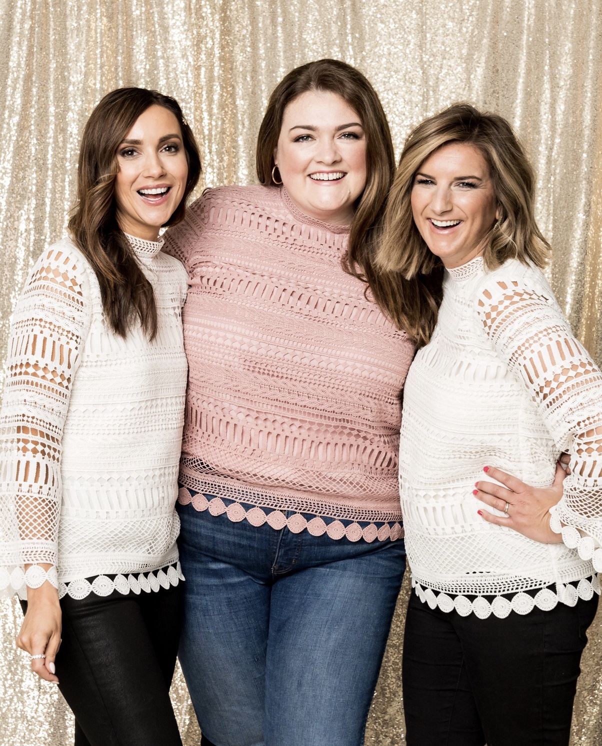 Three women wearing a lace crochet top