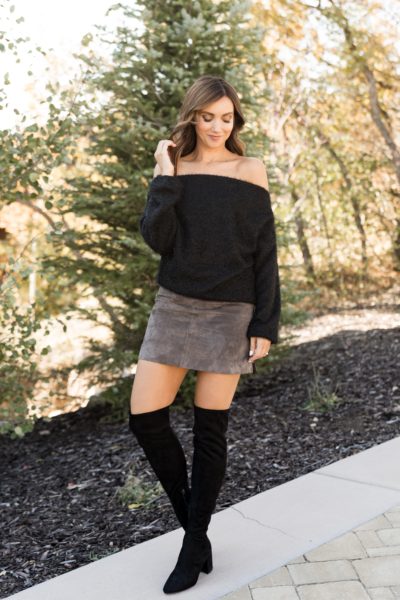 Off shoulder sweater paired with mini skit and OTK boots