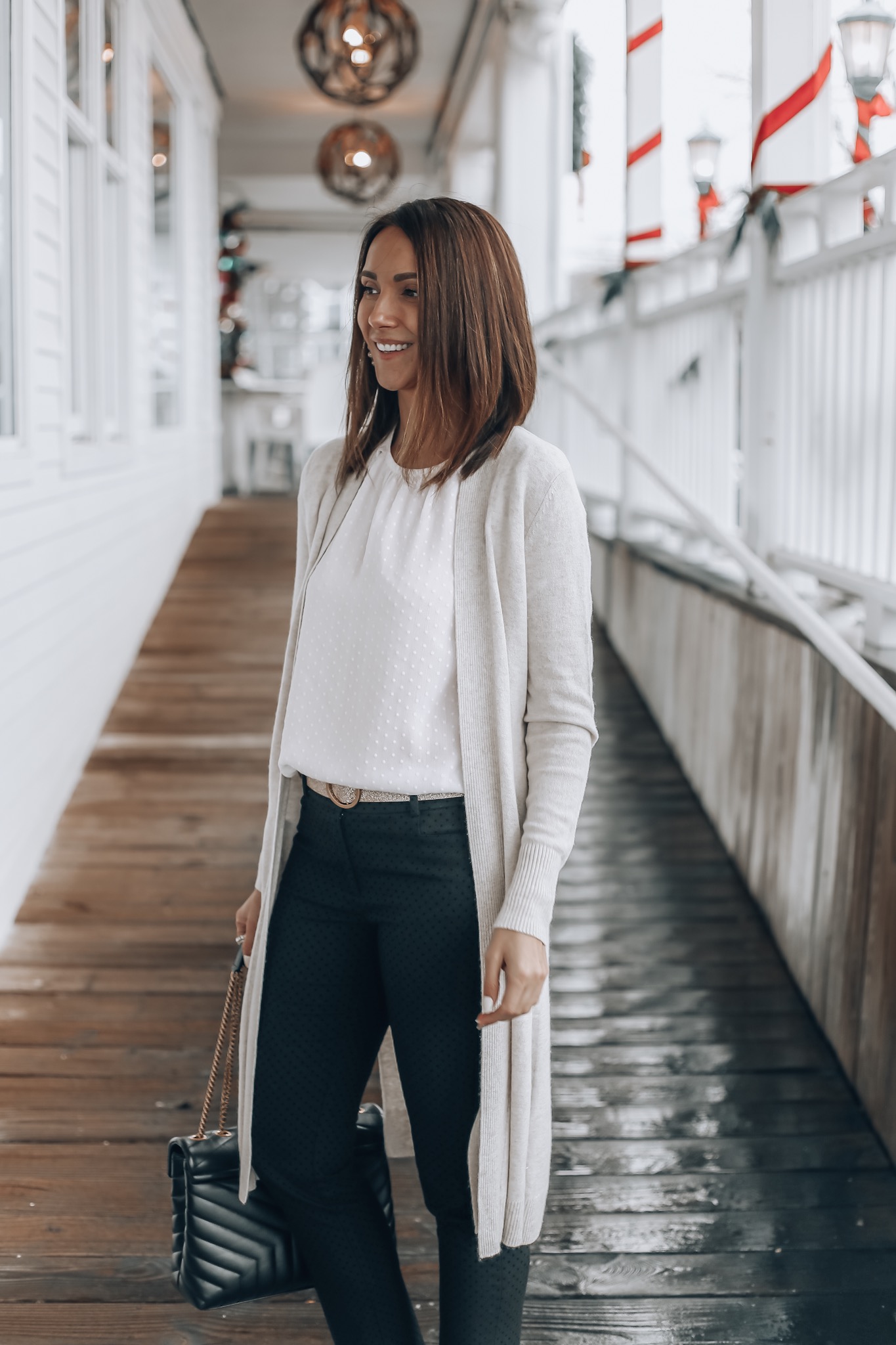 Woman wearing duster length cardigan, workwear style