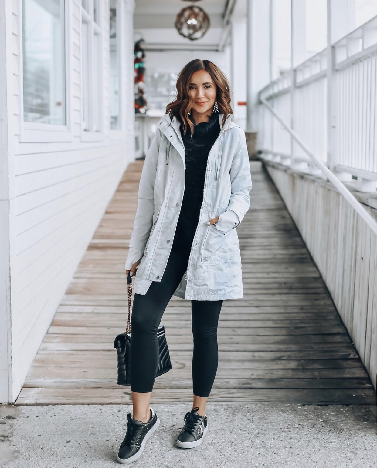 Woman wearing camo rain jacket, athleisure wear