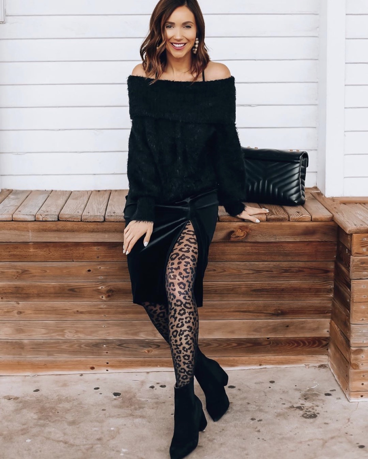 Woman wearing slip dress, sweater and leopard print tights