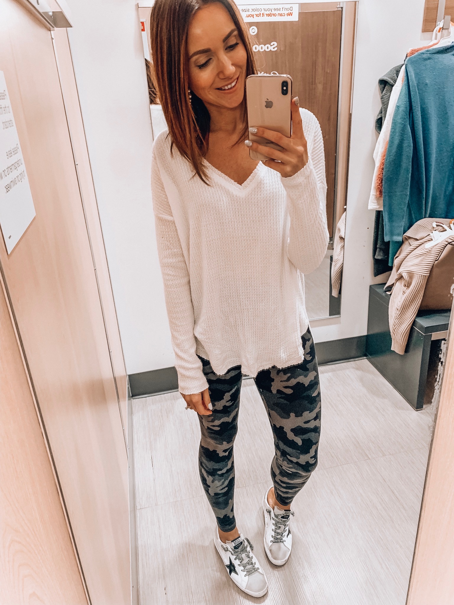 Woman wearing cozy v neck tee, camo leggings, cozy style