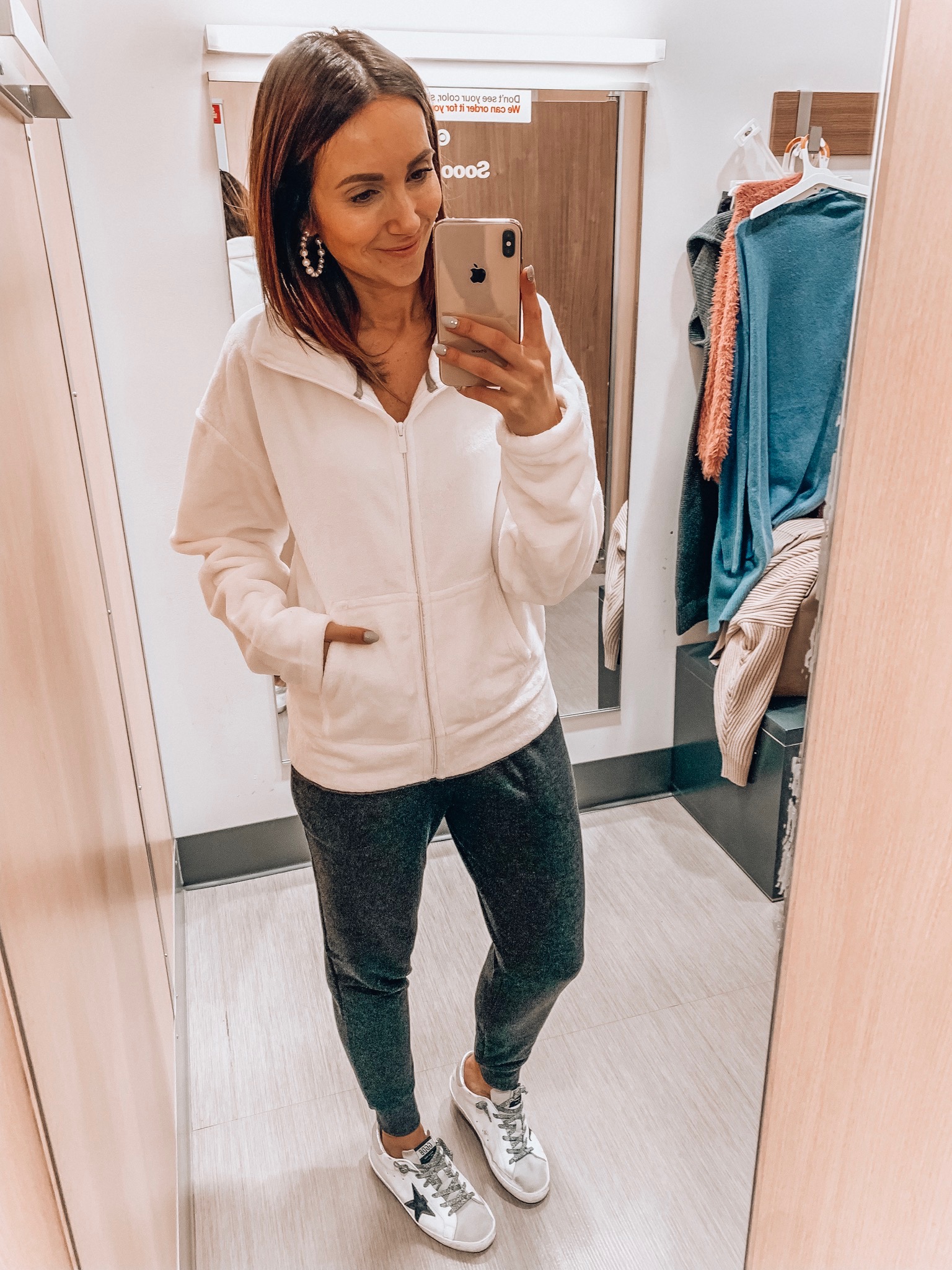 woman wearing zip up sherpa and fleece joggers