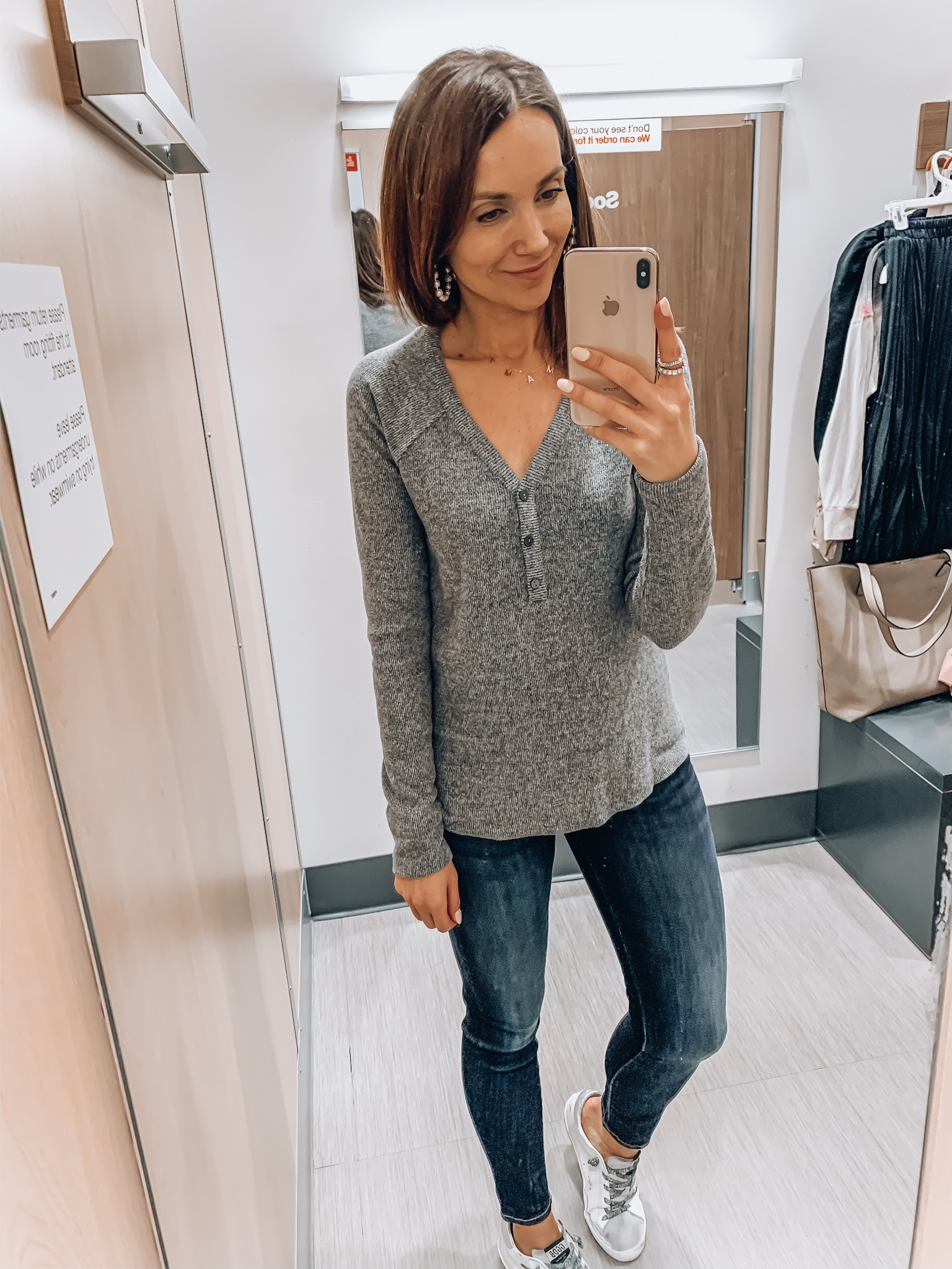 woman wearing henley with jeans