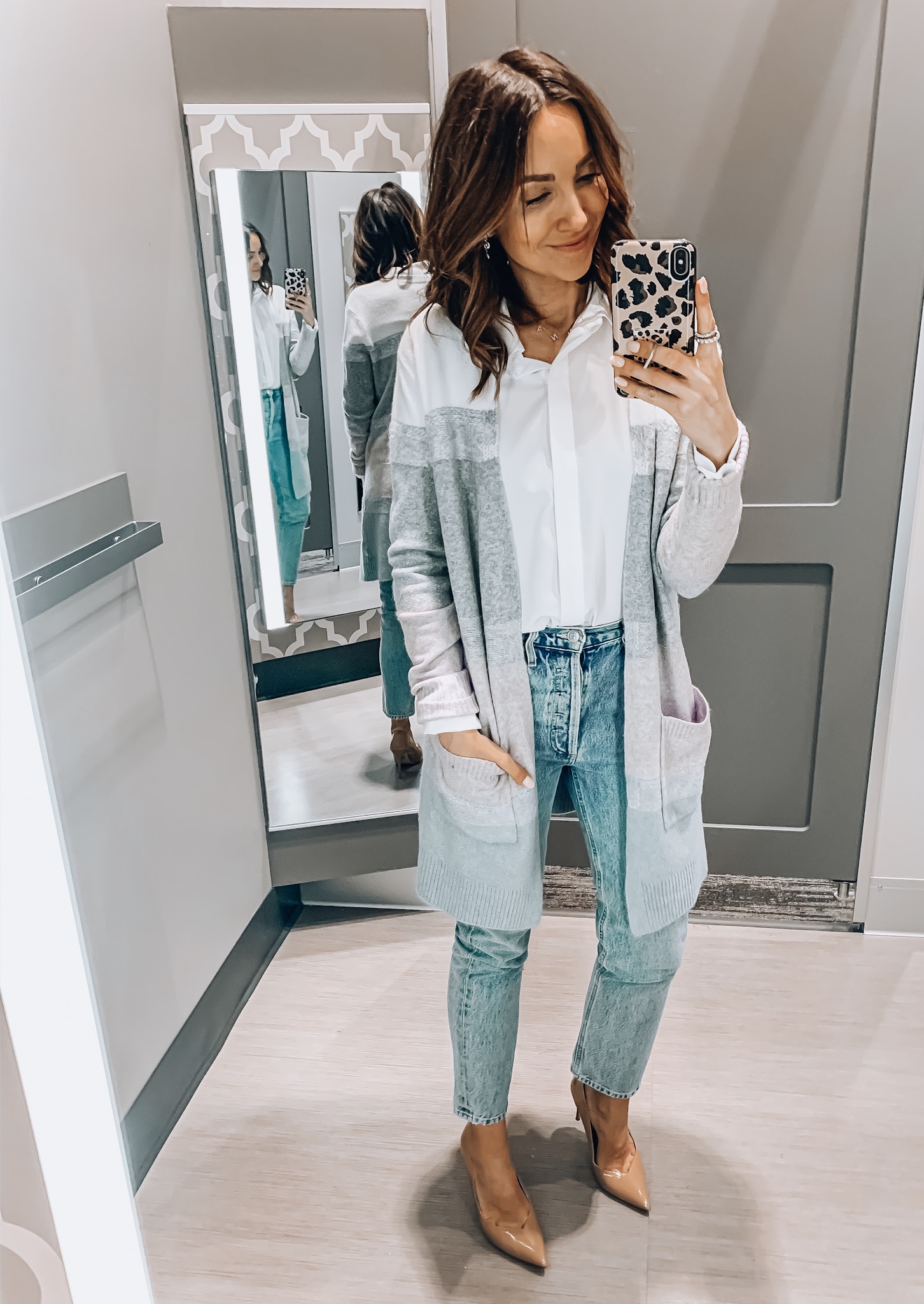 woman wearing white blouse with cardigan and jeans