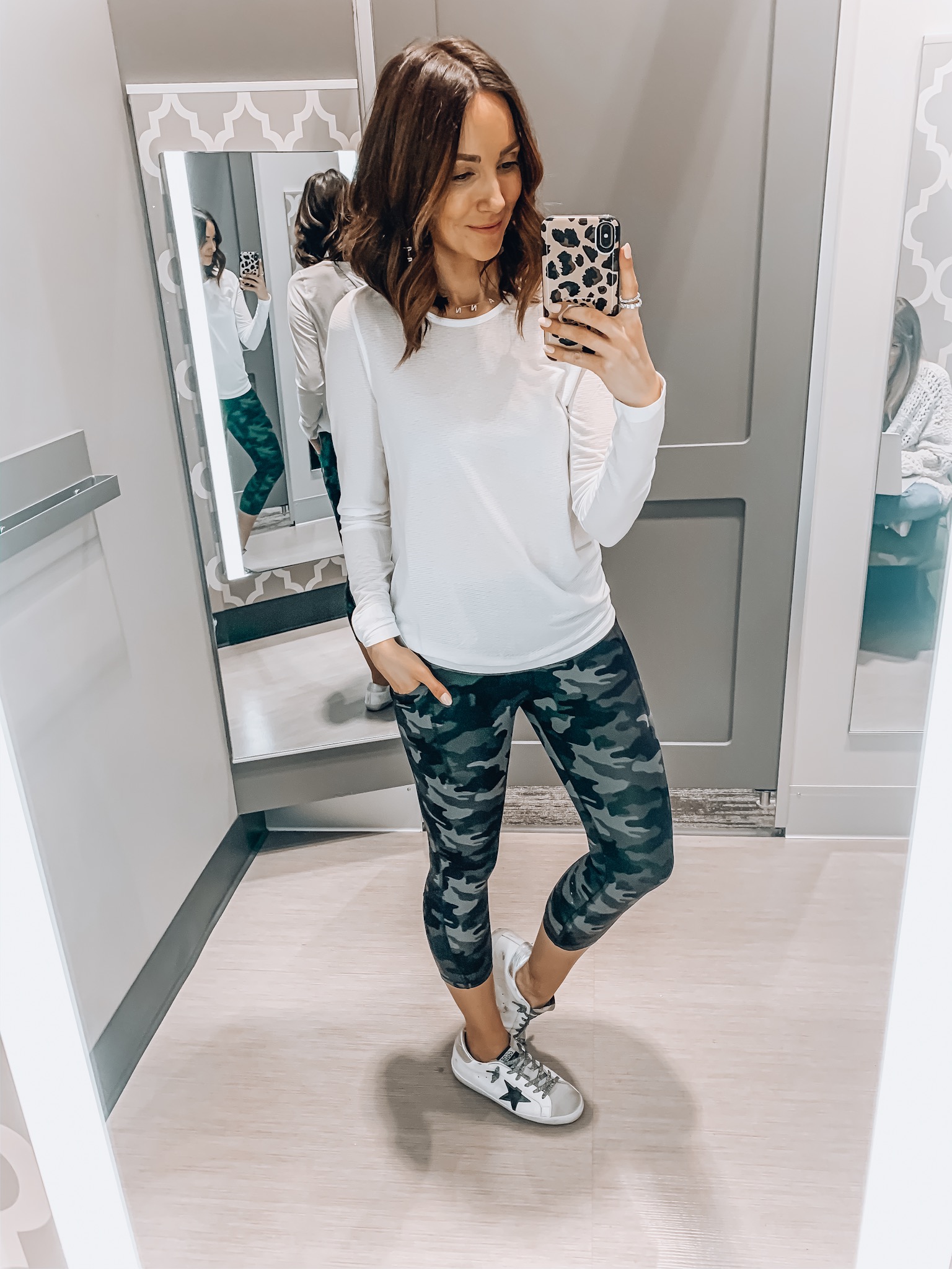 woman wearing camo leggings, white tee