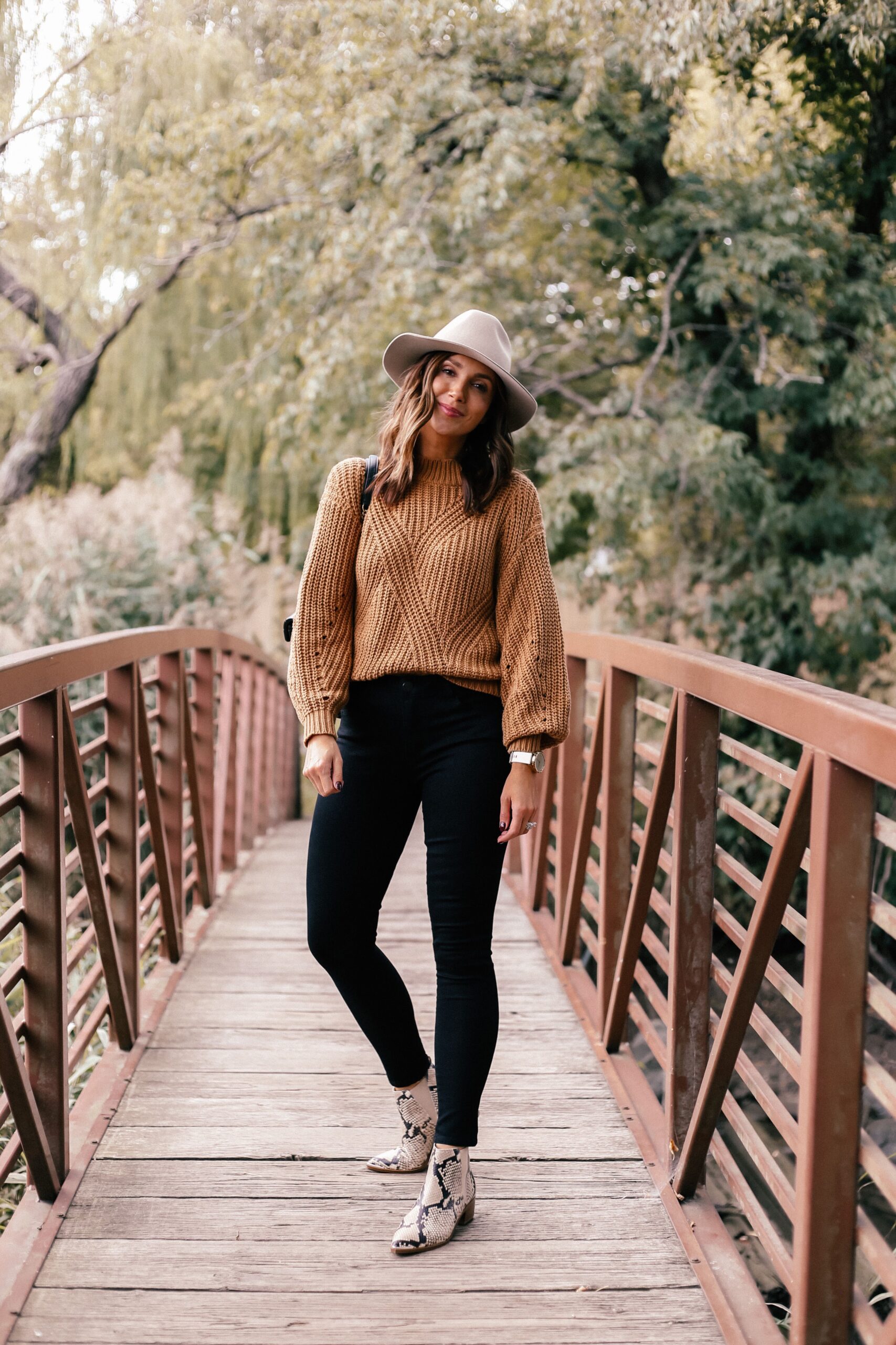 fall outfit with black jeans and brown sweater