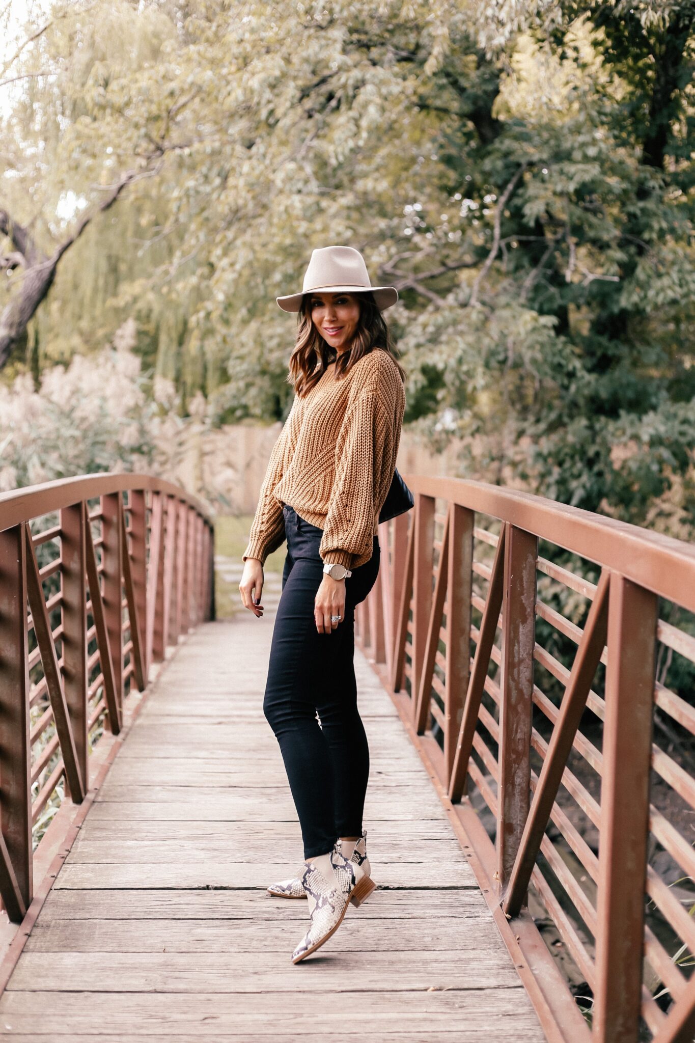 fall outfit idea with black jeans, snakeskin boots and hat