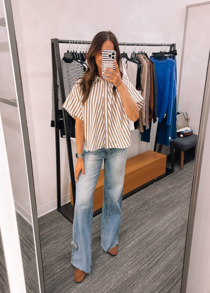 Brown and white striped button-front blouse paired with wide-leg jeans and brown boots, a chic casual workwear outfit for fall.