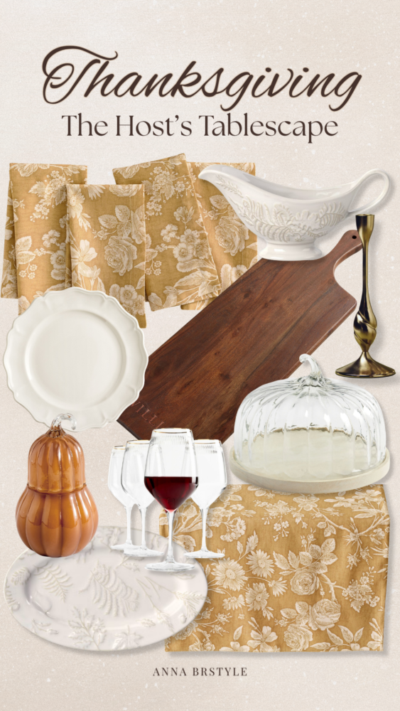 Thanksgiving table decor inspiration featuring floral napkins, white dinnerware, a gravy boat, wooden serving board, gold candlestick, and glass pumpkin dish.