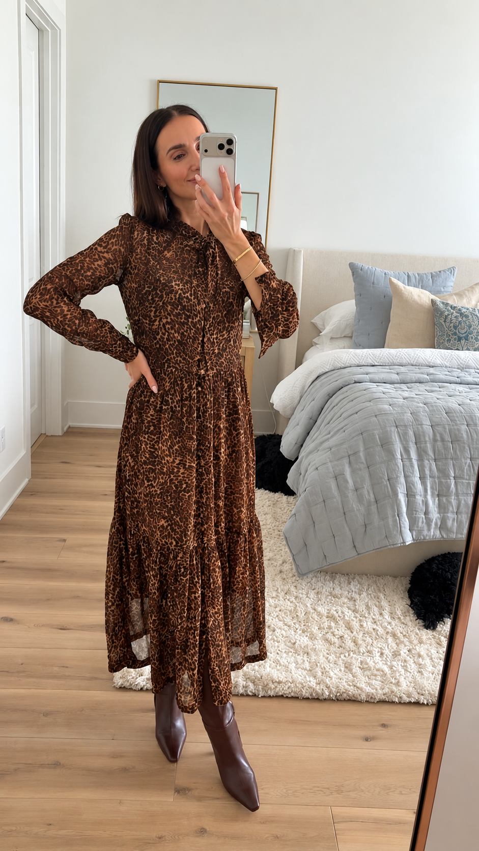 Long sleeve leopard print midi dress styled with chocolate brown pointed toe boots for a chic Thanksgiving or fall holiday outfit.
